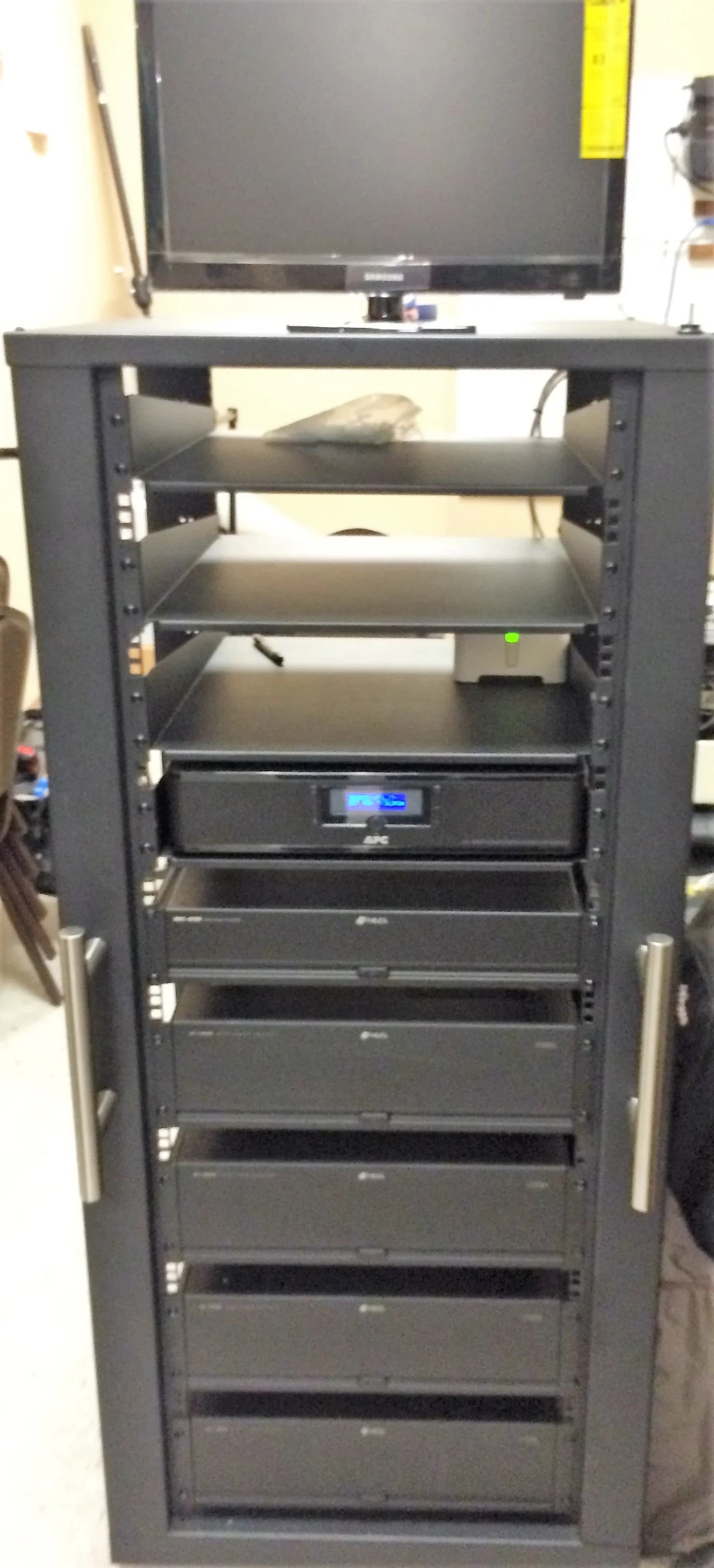 Rack-mounted amplifier front panel in a custom AV rack